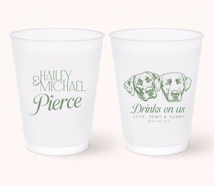 Two personalized frosted wedding cups featuring custom portraits of two dogs, the phrase "Drinks on Us," pet names Remy and Sunny, and personalized couple names Haley and Michael Pierce with the wedding date 02.14.27.
Personalized frosted wedding cups featuring two custom dog portraits and elegant wedding personalization.
Custom wedding drink cups with two pet portraits, couple names, and wedding date.