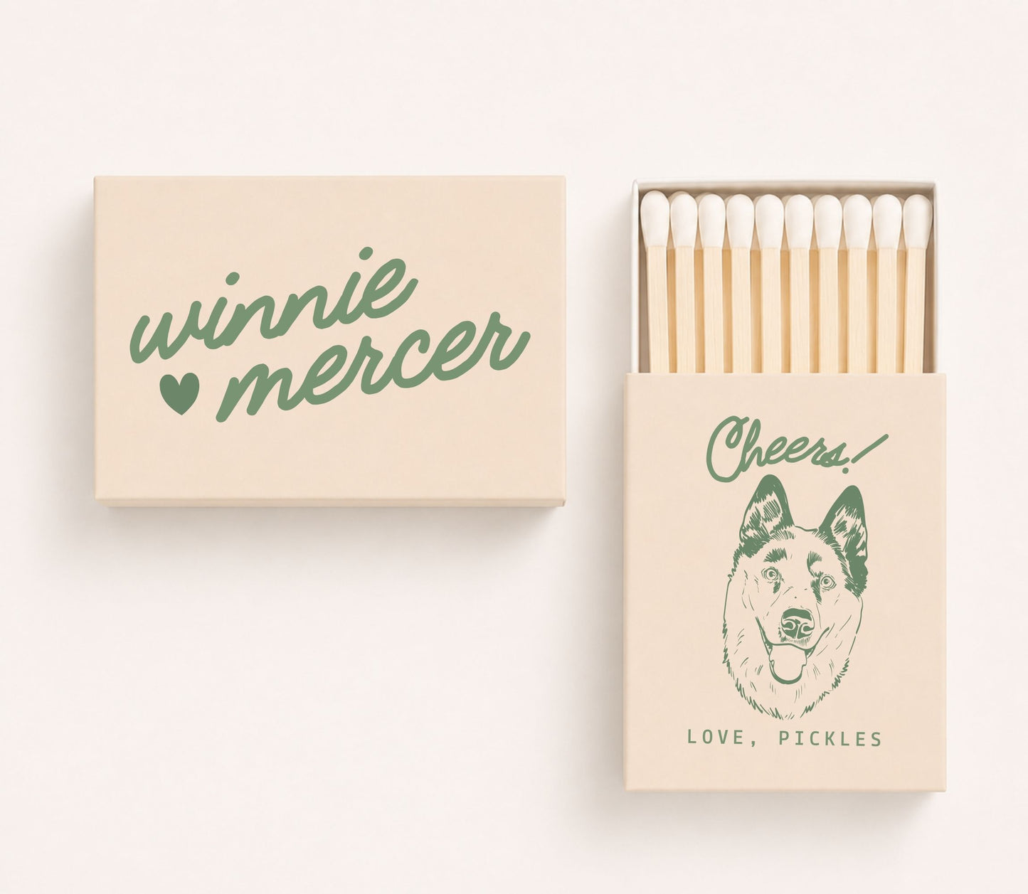Personalized wedding matchboxes featuring custom couple names Winnie and Mercer on the cover and a dog portrait illustration with the phrase "Cheers! Love, Pickles" on the sliding matchbox.