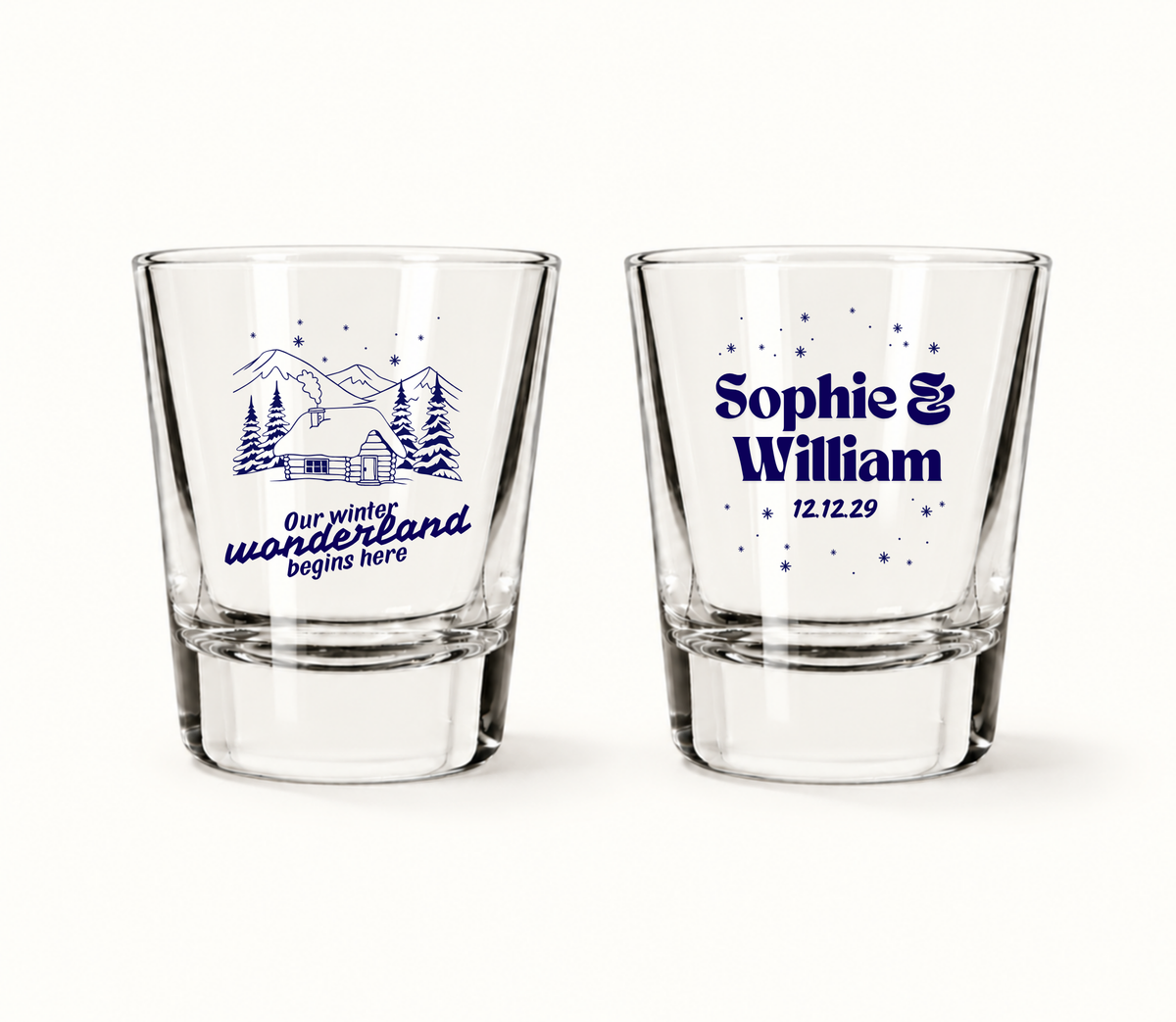 Personalized Winter Wonderland Christmas wedding shot glasses featuring snowy mountain cabin artwork, custom couple names, and wedding date.