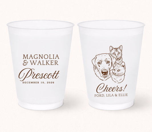 Personalized frosted wedding cups featuring custom illustrated dog and cat portraits with couple names, wedding date, and pet names for pet-friendly wedding celebrations.