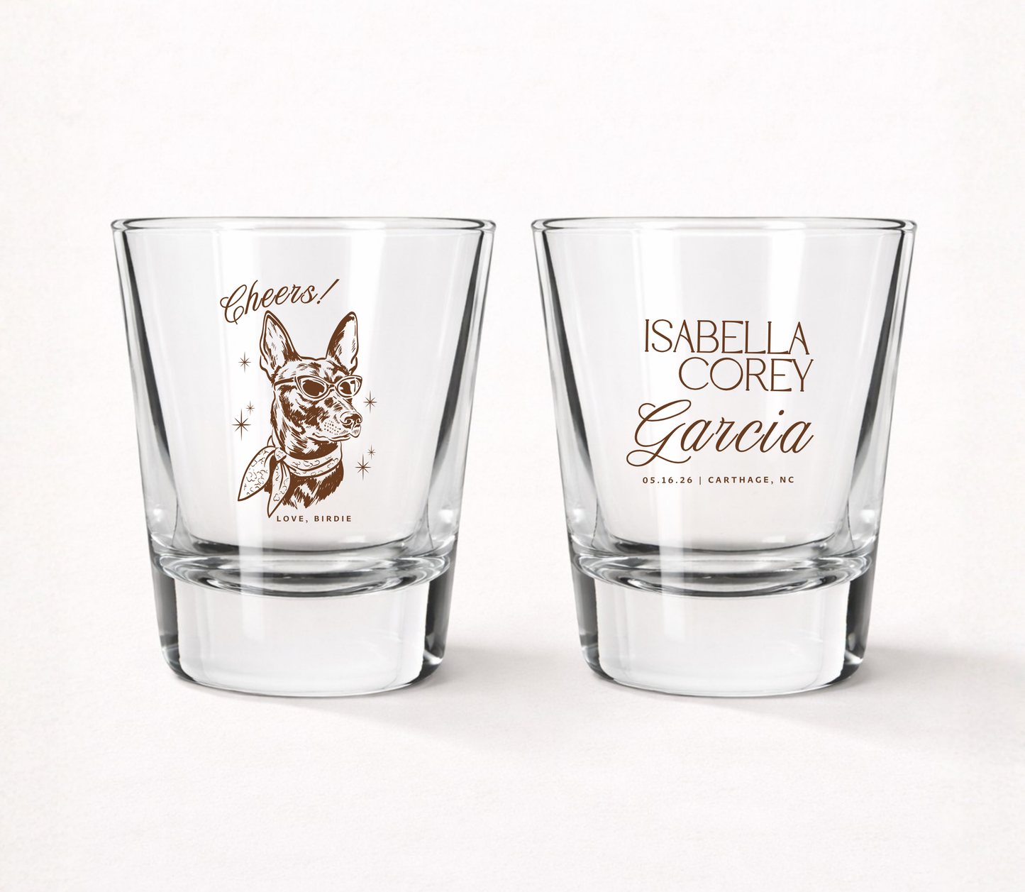 Clear personalized wedding shot glasses featuring a custom dog portrait illustration, couple names, wedding date, and elegant typography.