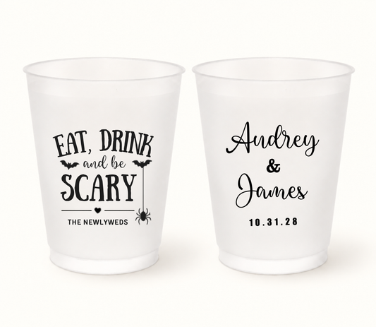 Personalized Eat, Drink and Be Scary Halloween wedding frosted cups featuring black bats, hanging spider, The Newlyweds wording, Audrey and James names, and wedding date 10.31.28.