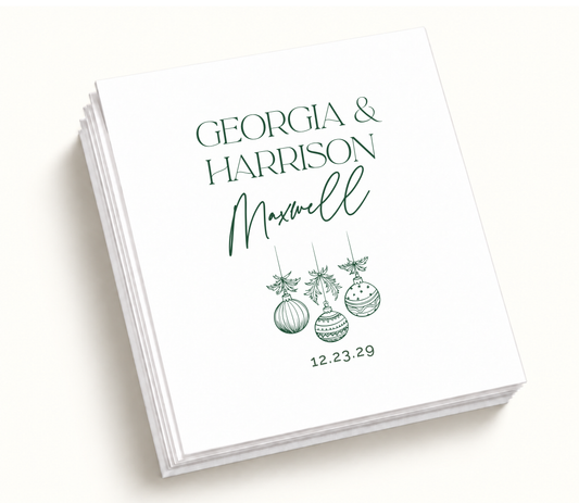 Personalized Christmas ornament wedding napkins with green holiday ornament artwork, couple names, and December wedding date.