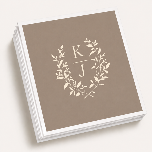 Taupe personalized monogram laurel wedding cocktail napkins featuring a botanical wreath and custom couple initials.