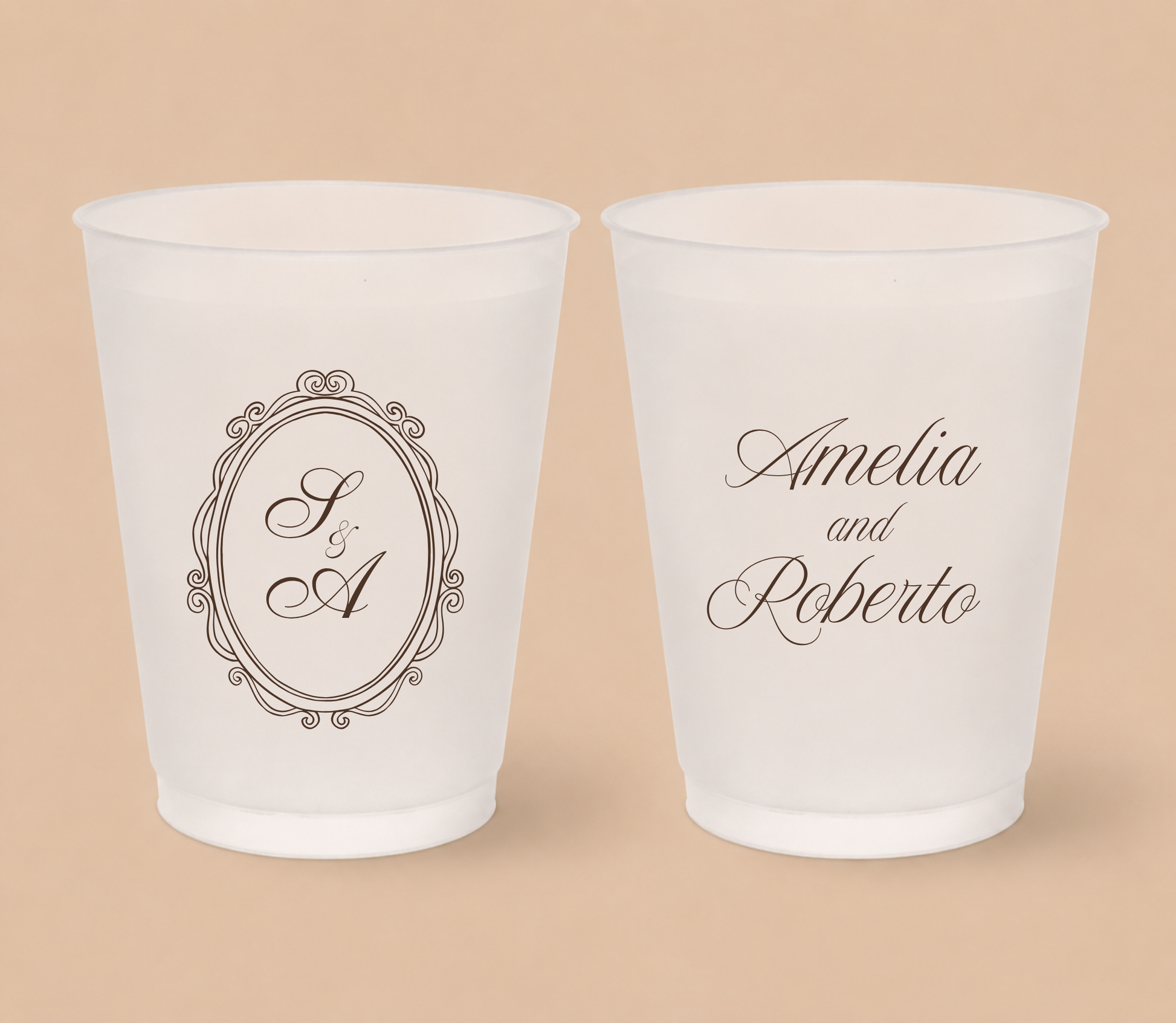White frosted wedding cups featuring a vintage oval crest monogram with custom initials A and R and personalized couple names Amelia and Roberto.
