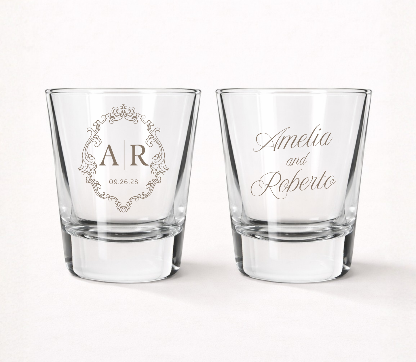 Personalized Elegant Monogram wedding shot glasses featuring custom initials, couple names, wedding date, and an ornate vintage frame design.