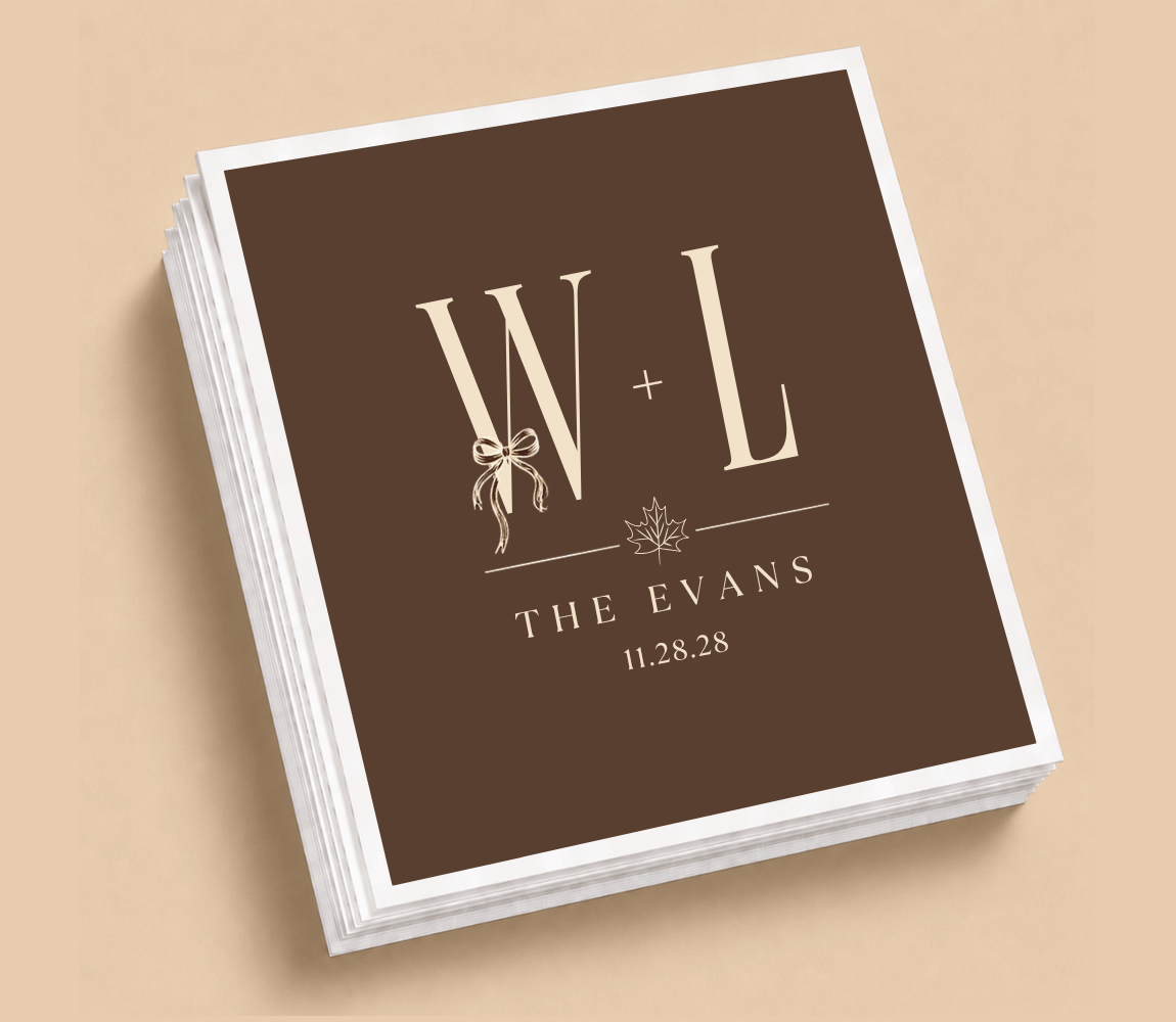 Personalized W + L Thanksgiving wedding table napkins with cream initials, bow and maple leaf details, custom family name, and wedding date.