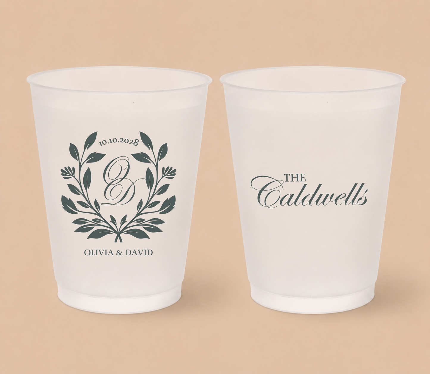 White frosted wedding cups featuring a botanical monogram wreath, custom initial D, couple names Olivia and David, family surname Caldwells, and wedding date.