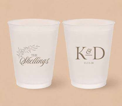 White frosted wedding cups featuring a botanical family surname design, custom initials K and D, and personalized wedding date.
