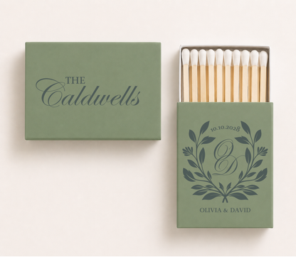Sage green personalized wedding matchboxes featuring the Caldwells family surname, botanical monogram with initials O and D, custom couple names Olivia and David, and wedding date.

Personalized sage green wedding matchbox featuring botanical monogram and custom surname.

Custom botanical wedding matchbox with couple names, monogram, and wedding date.