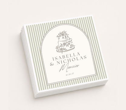 White personalized wedding table napkin featuring a hand-drawn floral wedding cake illustration, custom names Isabella and Nicholas Mercier, wedding date 10.10.27, framed with sage green pinstripes.
Personalized wedding table napkin featuring a vintage floral wedding cake illustration and custom couple names.
Elegant wedding reception napkin with hand-drawn cake artwork, personalized names, and wedding date.