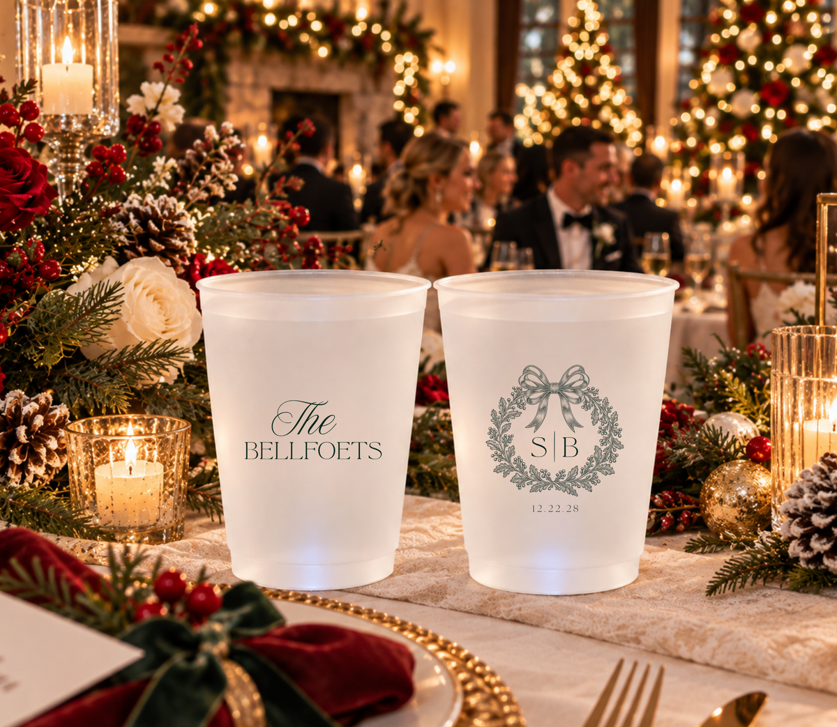 Custom holiday wedding cups featuring a Christmas bow wreath, couple initials, and wedding date.