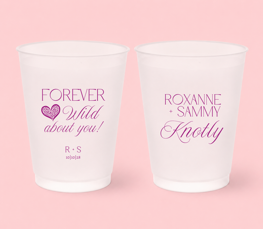 Personalized frosted wedding cups featuring magenta Forever Wild About You lettering, leopard print heart, Roxanne and Sammy names, Knotly surname, initials, and 10-10-28 wedding date.