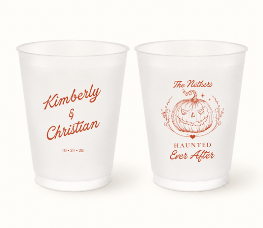 Personalized Haunted Ever After frosted Halloween wedding cups featuring burnt-orange jack-o’-lantern artwork, Kimberly and Christian names, The Netkers last name, and wedding date 10.31.28.