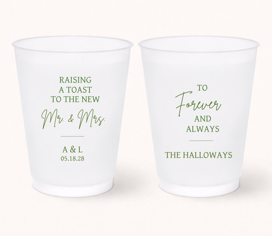 Personalized frosted wedding cups featuring green Raising a Toast to the New Mr. and Mrs. lettering, A and L initials, 05.18.28 wedding date, and The Halloways family name.
