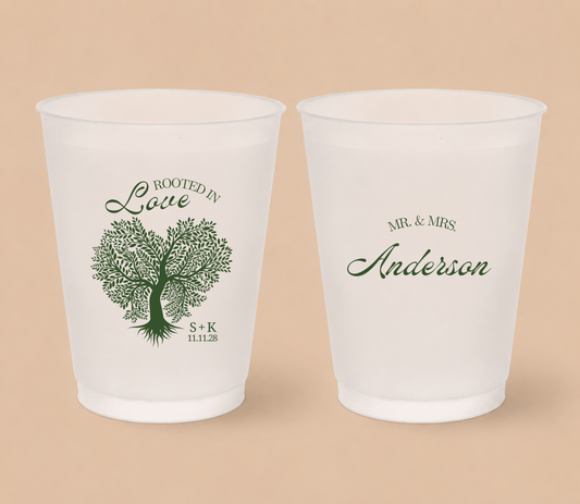 White frosted wedding cups featuring a Rooted In Love tree illustration with personalized family surname, couple initials, and wedding date