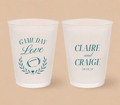 Personalized Game Day Love football wedding cups featuring a football, laurel wreath, heart detail, teal lettering, and custom couple names.