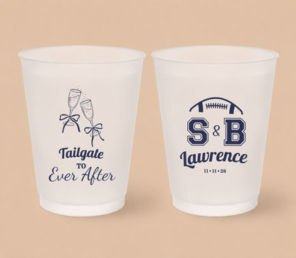 Personalized Tailgate To Ever After football wedding cups featuring champagne glass artwork, football-inspired initials, custom surname, and wedding date.