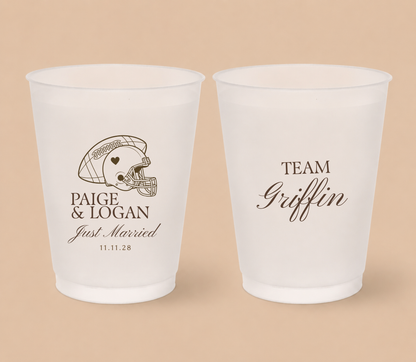 Personalized football helmet wedding cups featuring Paige and Logan, a heart football helmet, Just Married wording, and Team Griffin design.