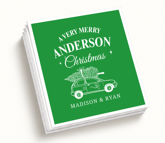 Personalized A Very Merry Christmas wedding napkins featuring green background, white vintage Christmas car illustration, tree artwork, and custom couple names.