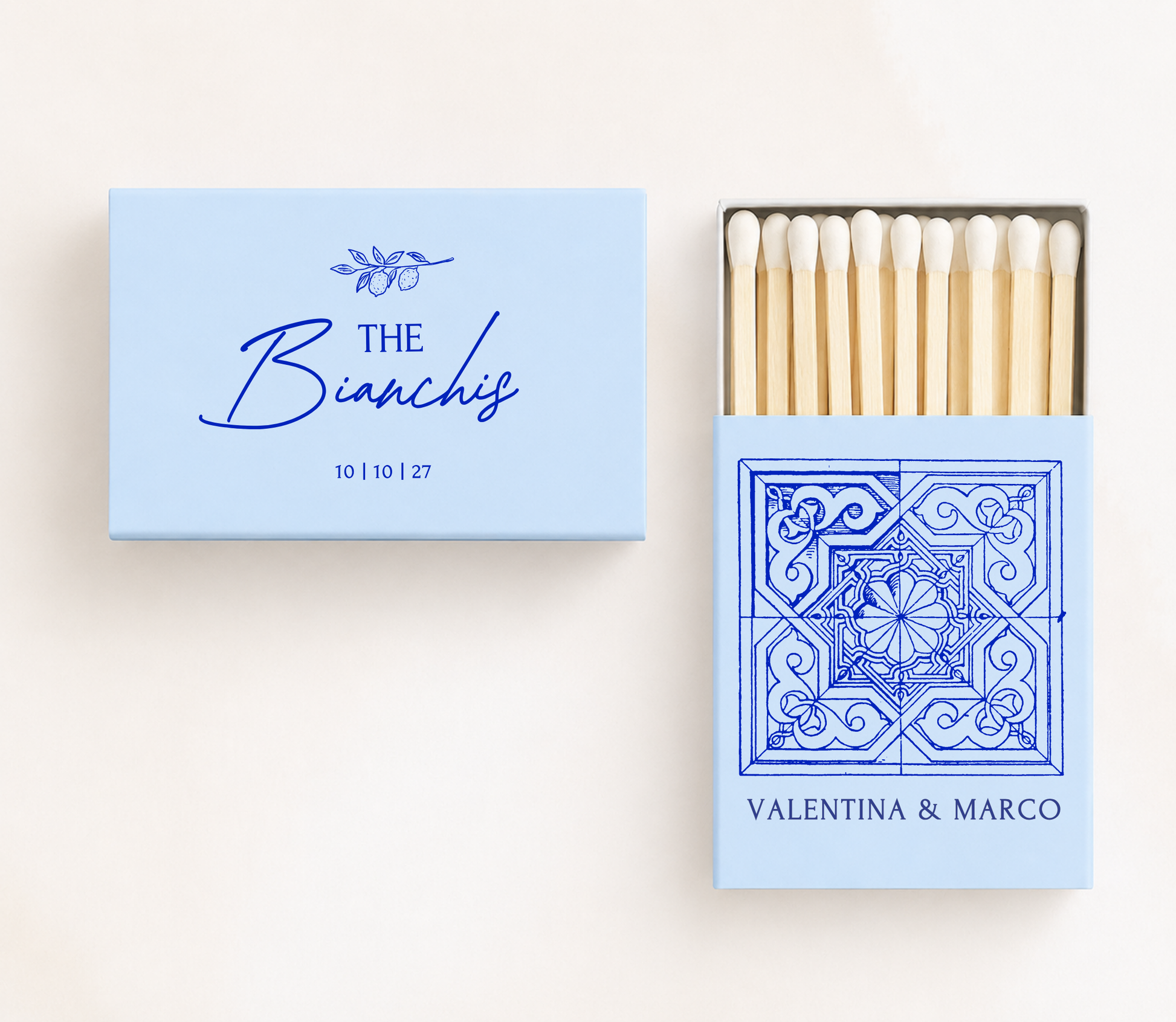 Personalized Italian tile wedding matchboxes featuring a Mediterranean ceramic tile illustration, custom names, family name, and wedding date.