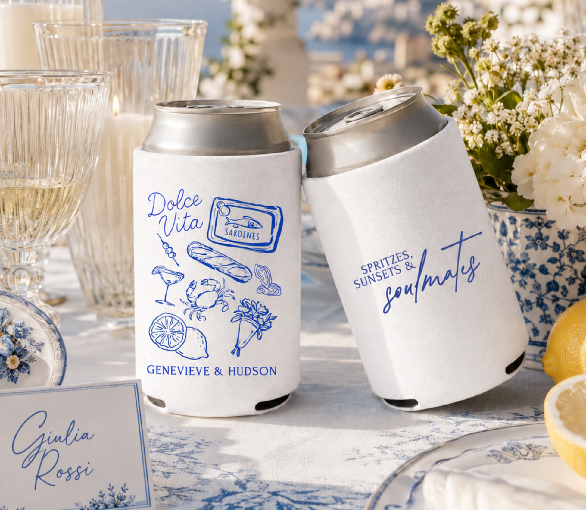 Custom Dolce Vita destination wedding can coolers with blue Italian coastal artwork, sardine tin illustration, lemons, cocktail details, and personalized names on white drink sleeves