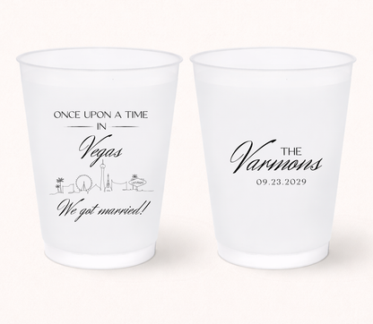 Custom Las Vegas wedding frosted cups with personalized names, destination inspired skyline artwork, and wedding details