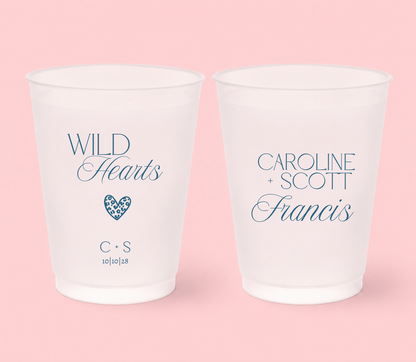 Personalized frosted wedding cups featuring blue Wild Hearts lettering, leopard print heart, Caroline and Scott names, Francis surname, initials, and 10-10-28 wedding date.