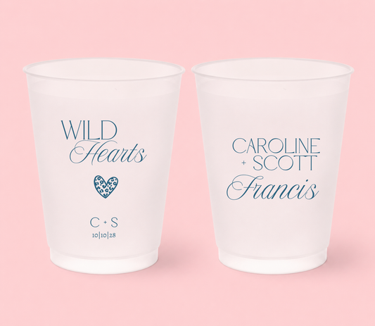 Personalized frosted wedding cups featuring blue Wild Hearts lettering, leopard print heart, Caroline and Scott names, Francis surname, initials, and 10-10-28 wedding date.