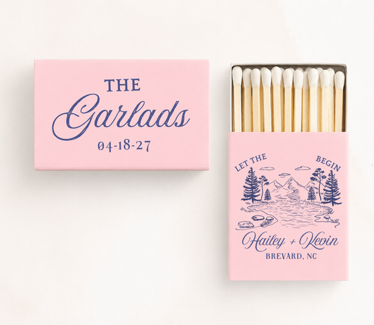 Personalized "Let The Adventure Begin" wedding matchboxes featuring custom family name, couple names, wedding location, date, and mountain landscape illustration.