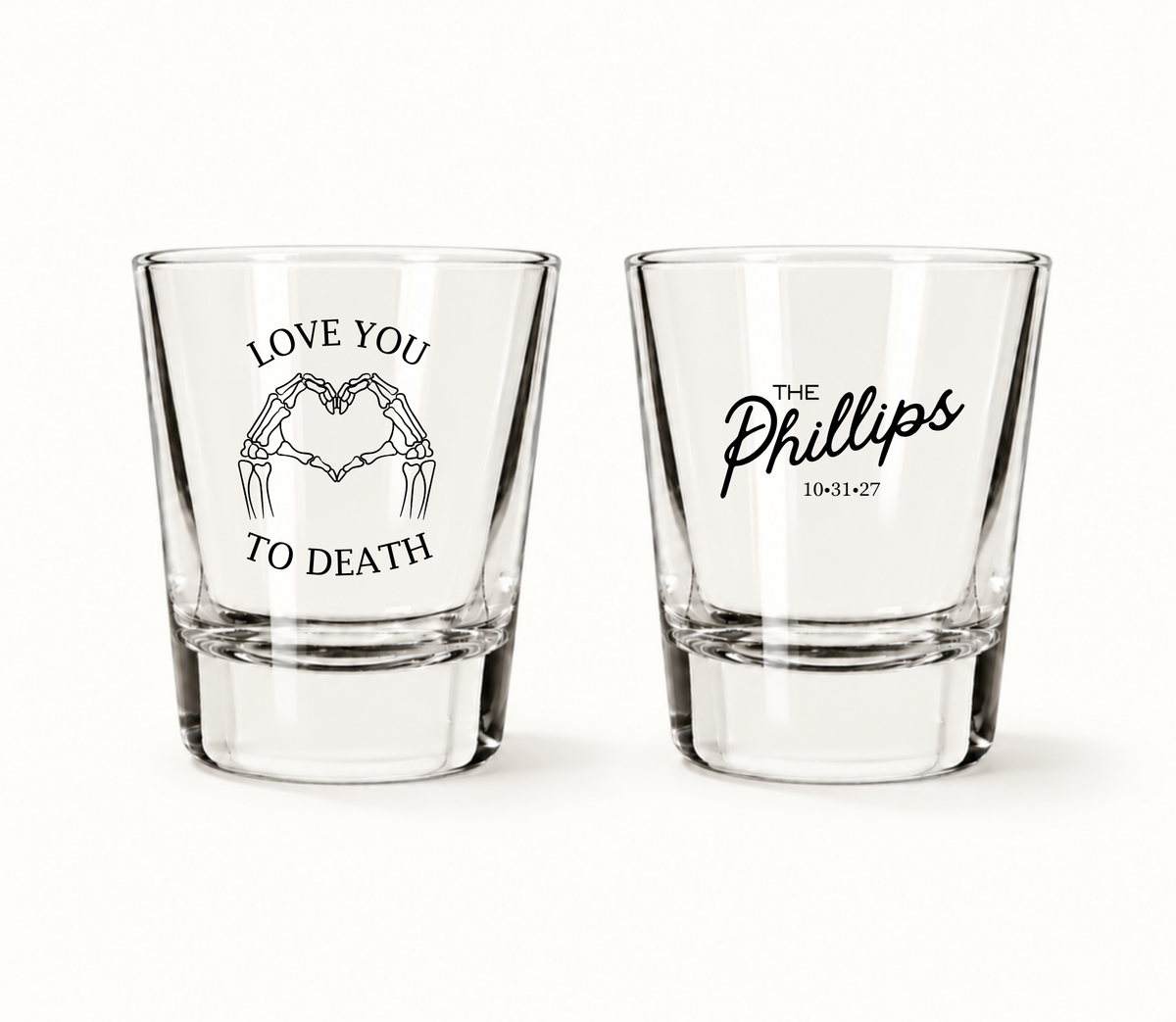 Personalized Love You to Death Halloween wedding shot glasses featuring skeleton hands forming a heart, The Phillips surname, and wedding date 10.31.27.