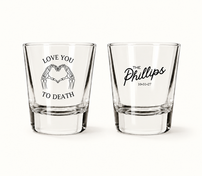 Personalized Love You to Death Halloween wedding shot glasses featuring skeleton hands forming a heart, The Phillips surname, and wedding date 10.31.27.