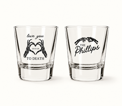 Personalized Love You to Death wedding shot glasses featuring black skeleton hands forming hearts, wedding date 10.31.28, and The Phillips personalized surname design.