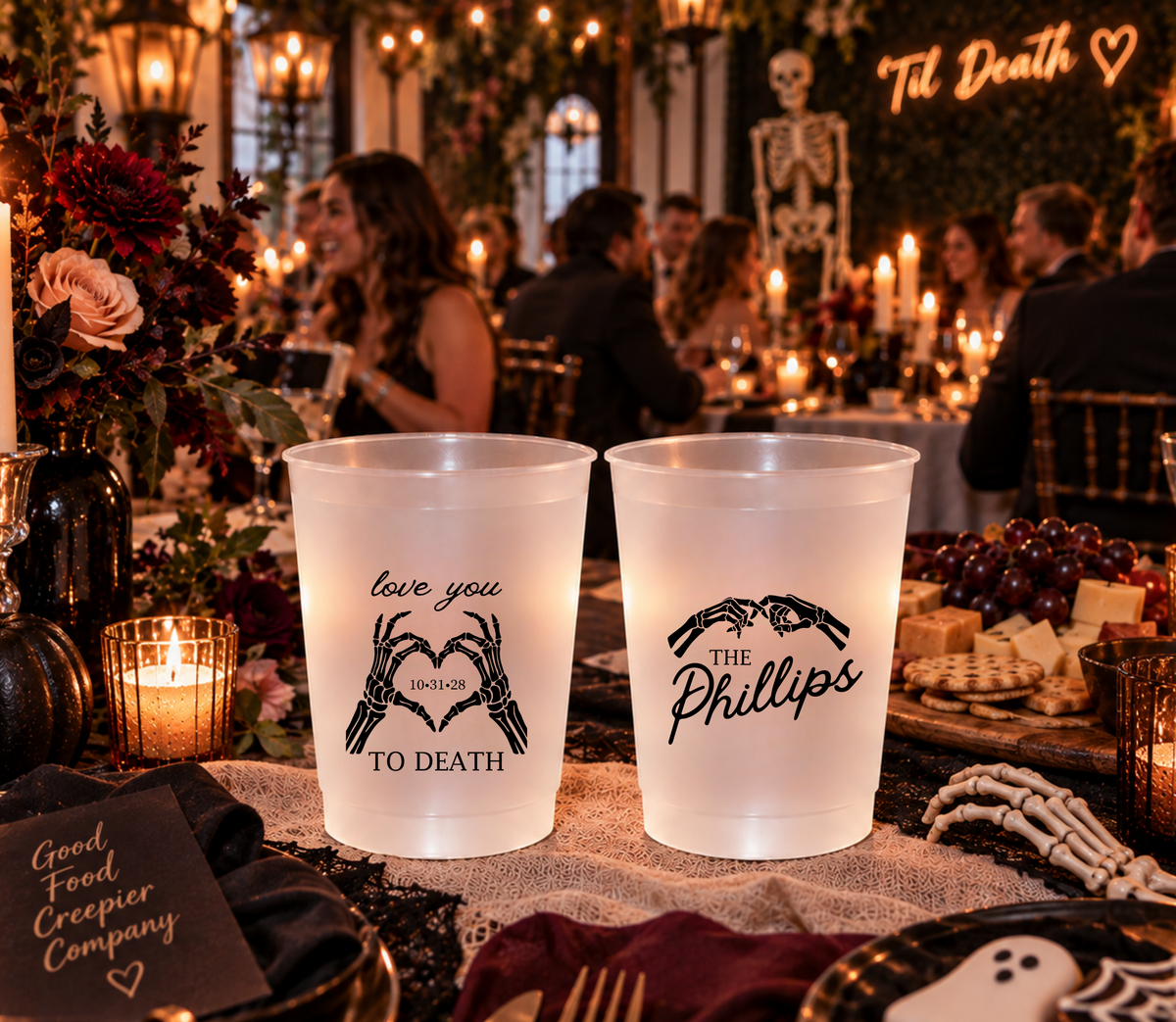 Personalized frosted Halloween wedding cup featuring The Phillips last name and black skeleton hand heart artwork.