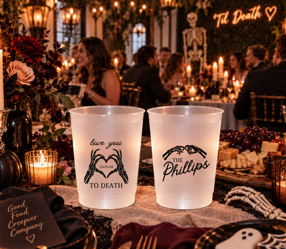 Personalized frosted Halloween wedding cup featuring The Phillips last name and black skeleton hand heart artwork.