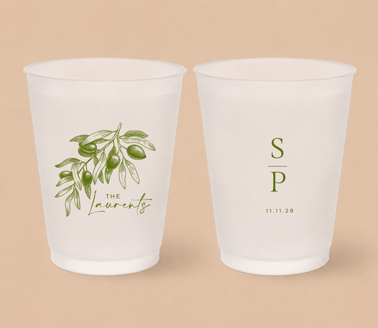 White frosted wedding cups featuring a vintage olive branch illustration with personalized family surname, couple initials, and wedding date.
