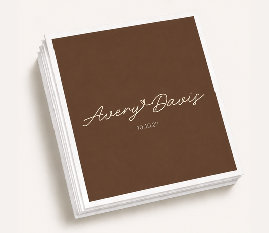 Personalized minimalist wedding cocktail napkins featuring a custom couple name in elegant script with a wedding date for modern wedding receptions and cocktail hours.