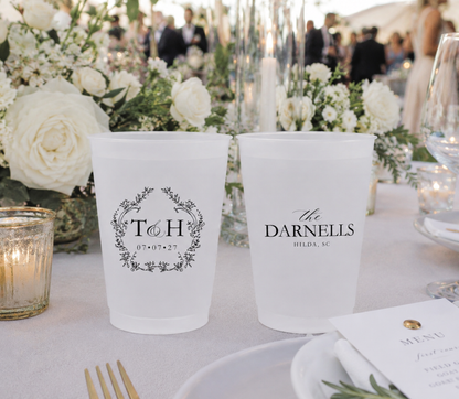 Personalized botanical monogram wedding frosted cups featuring floral wreath initials family name and wedding date