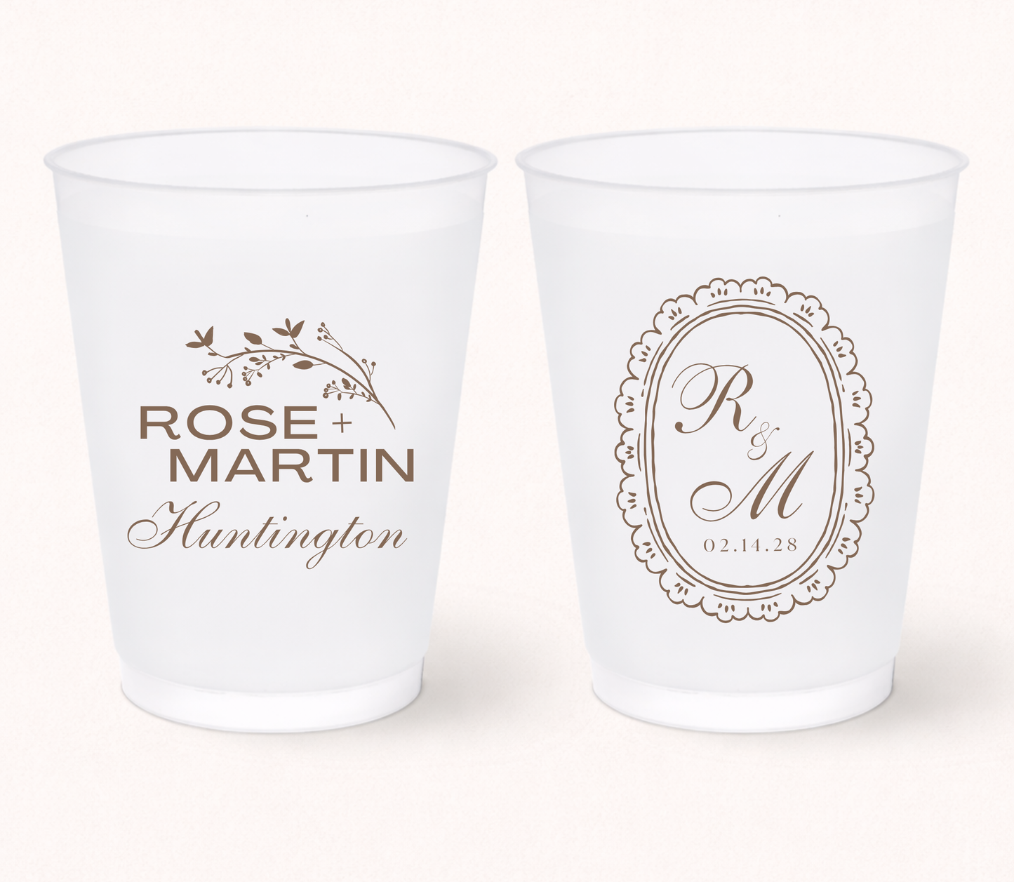 Two white frosted cups with personalized designs on a white background
