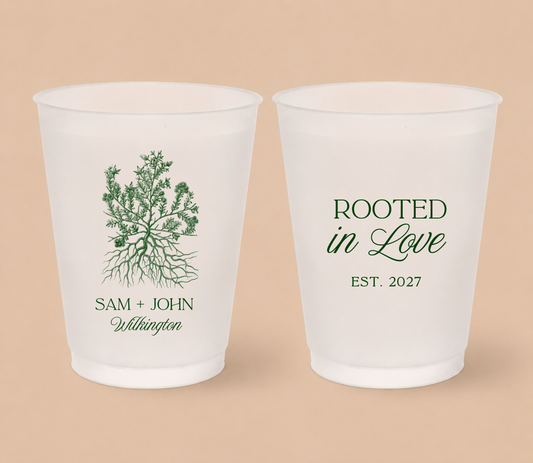 White frosted wedding cups featuring a botanical roots illustration with personalized couple names, family surname, and Rooted In Love design.