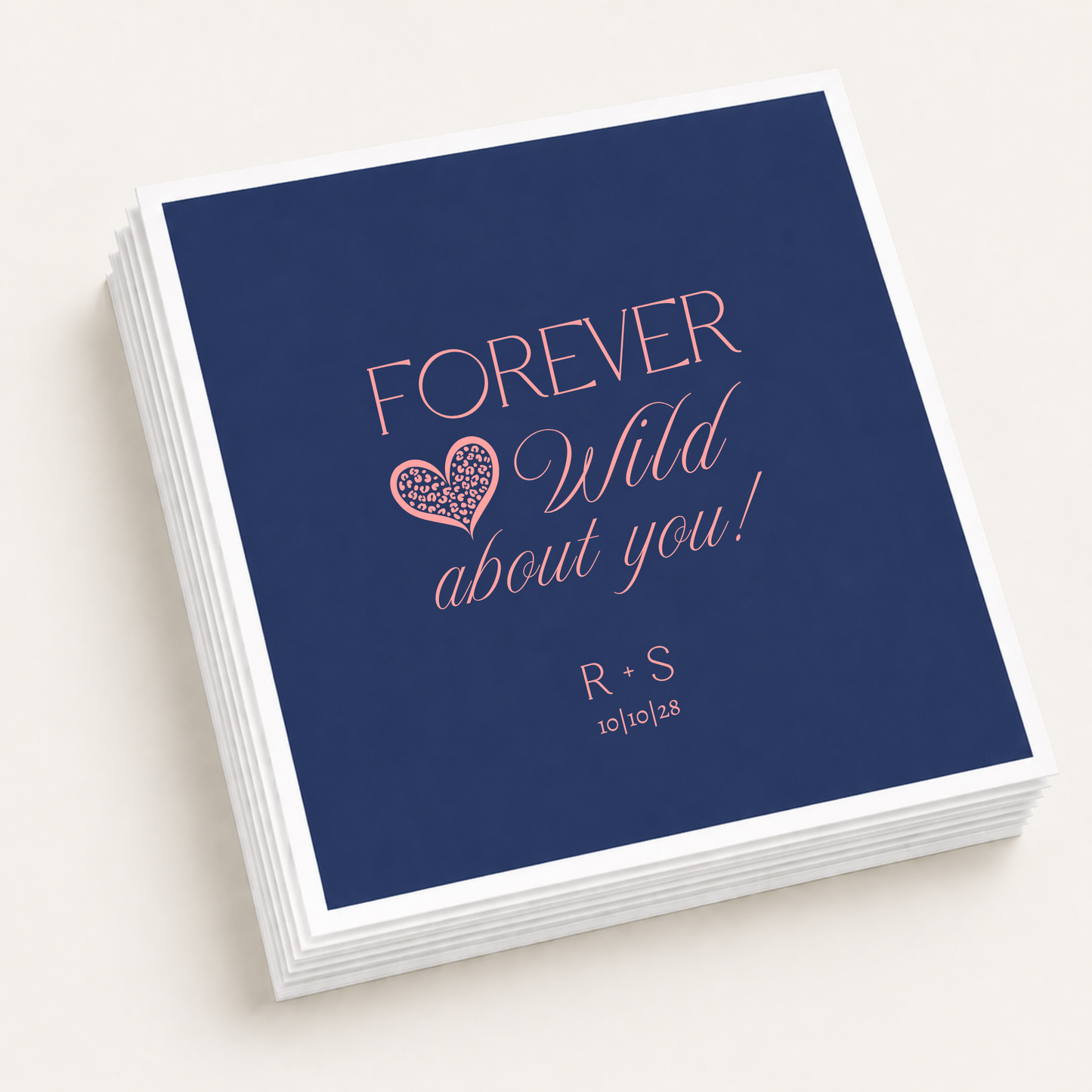 Personalized navy wedding cocktail napkins featuring Forever Wild About You wording, a coral pink leopard print heart, R and S couple initials, and 10-10-28 wedding date.
