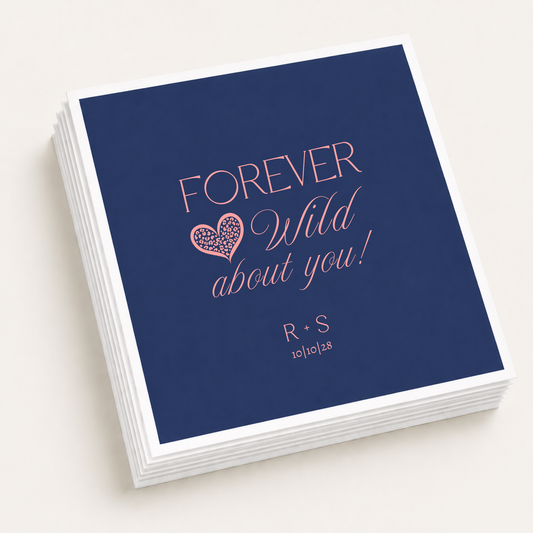 Personalized navy wedding cocktail napkins featuring Forever Wild About You wording, a coral pink leopard print heart, R and S couple initials, and 10-10-28 wedding date.
