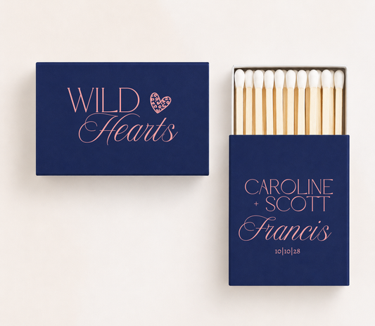 Personalized navy wedding matchboxes featuring coral pink Wild Hearts lettering, leopard print heart, Caroline and Scott names, Francis family name, and 10-10-28 wedding date.