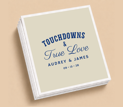 Personalized Touchdowns & True Love football wedding napkins featuring navy blue lettering, elegant script, custom couple names, and wedding date.