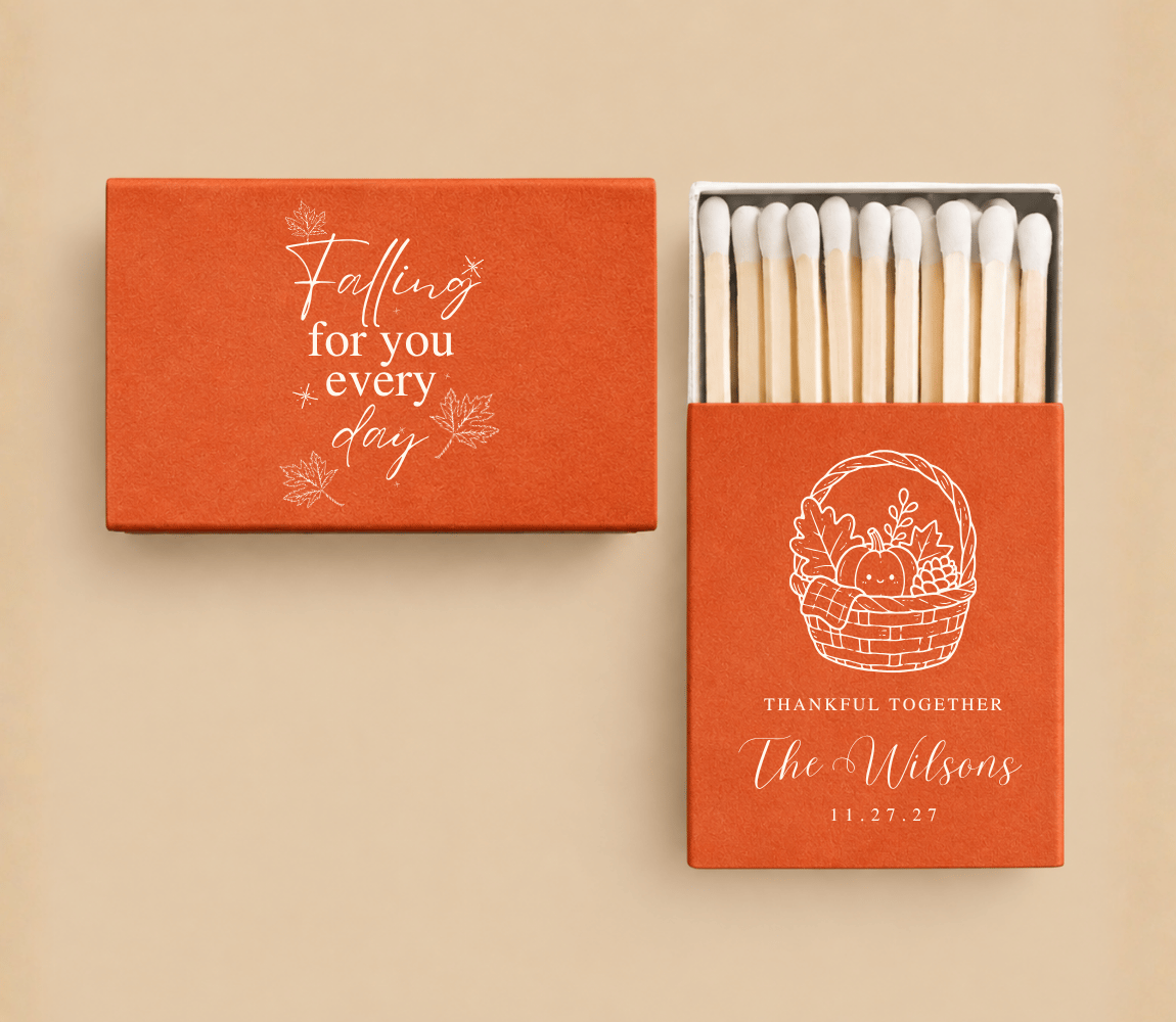 Personalized Thanksgiving wedding matchboxes in orange featuring a harvest basket, pumpkins, custom couple names, and fall-inspired typography.