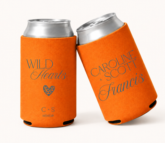 Personalized bright orange wedding can coolers featuring Wild Hearts wording with a leopard print heart, couple initials and wedding date, and Caroline and Scott Francis names in blue lettering.