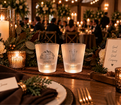 Mountain wedding shot glasses featuring crossed skis, alpine scenery, couple names, and wedding date.
