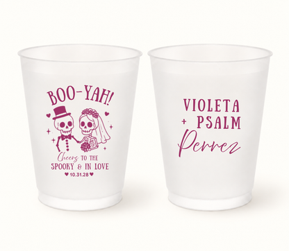 Personalized Boo-Yah Halloween wedding frosted cups featuring a cute skeleton bride and groom, Cheers to the Spooky & in Love wording, custom couple names, and wedding date.