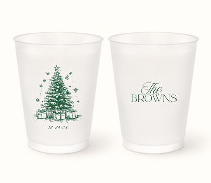 Personalized Christmas wedding frosted cups featuring a detailed Christmas tree, custom family name, wedding date, snowflakes, ornaments, and presents.