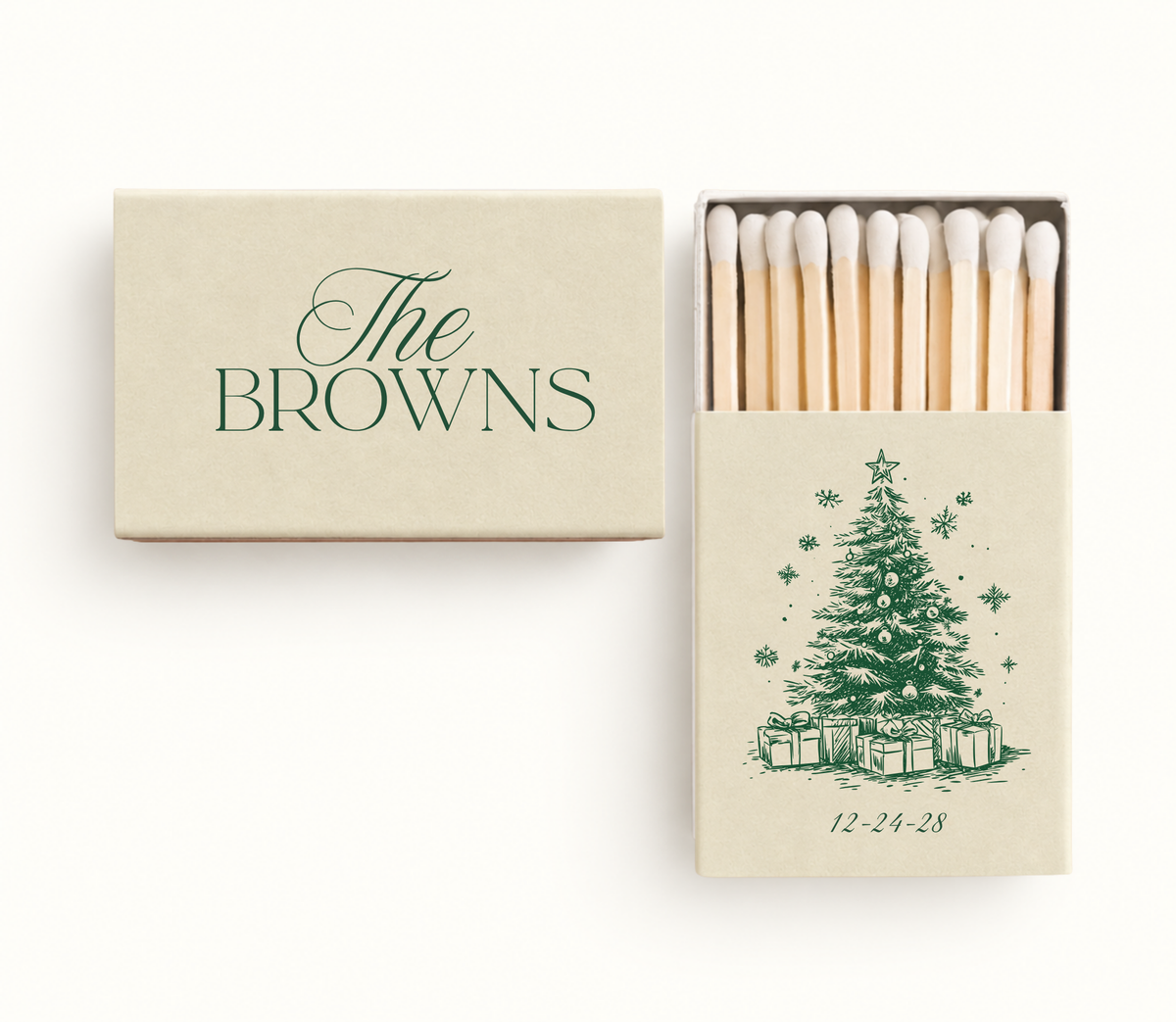 Personalized Christmas wedding matchboxes featuring a cream cover, custom family name, green Christmas tree illustration, and wedding date.